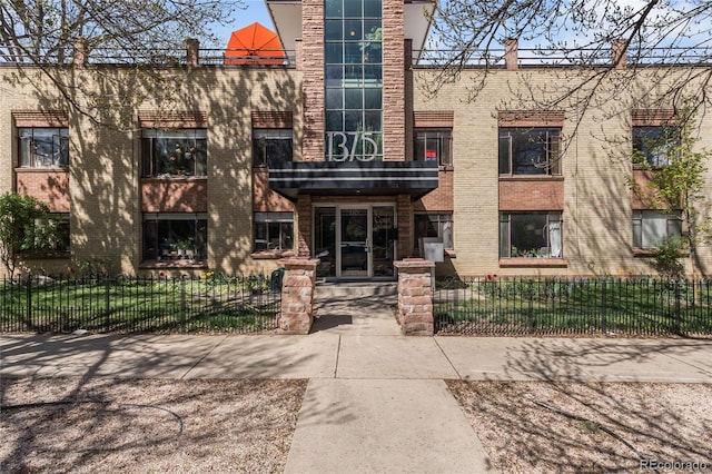 view of building exterior featuring a fenced front yard