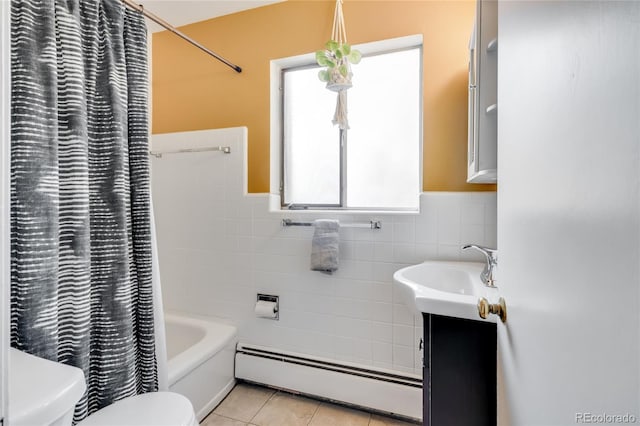 bathroom with vanity, toilet, tile walls, tile patterned floors, and a baseboard heating unit