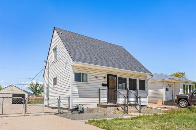 235 S 8th Ave, Brighton, CO 80601 - view of front of home with a gate and a shingled roof