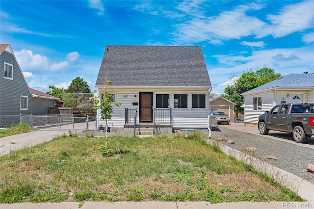 235 S 8th Ave, Brighton, CO 80601 - view of front facade with a gate and roof with shingles