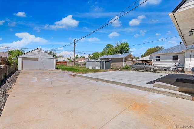 235 S 8th Ave, Brighton, CO 80601 - view of patio featuring an outdoor structure, a residential view, and a garage