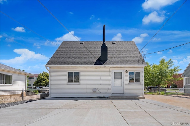 235 S 8th Ave, Brighton, CO 80601 - rear view of property with a shingled roof