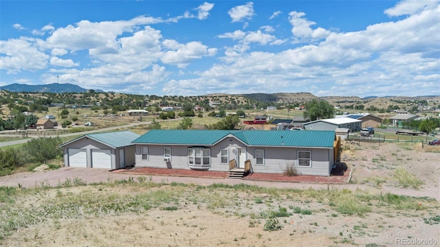 view of front facade featuring a mountain view and a garage