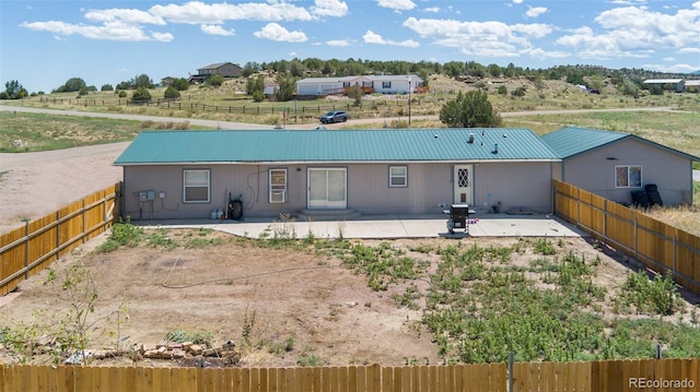 rear view of property featuring a patio area