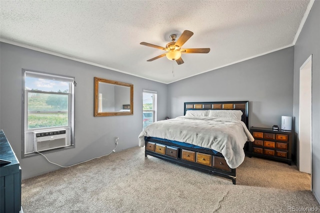 carpeted bedroom with vaulted ceiling, ceiling fan, crown molding, and a textured ceiling