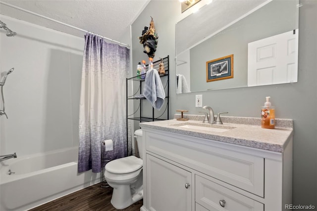 full bathroom featuring hardwood / wood-style floors, a textured ceiling, toilet, shower / tub combo with curtain, and vanity