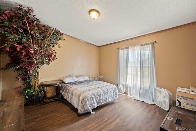 bedroom featuring a textured ceiling, crown molding, and dark wood-type flooring