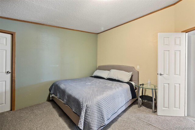 carpeted bedroom with a textured ceiling and ornamental molding