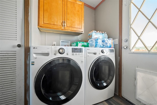 laundry room featuring dark hardwood / wood-style flooring, cabinets, ornamental molding, and separate washer and dryer