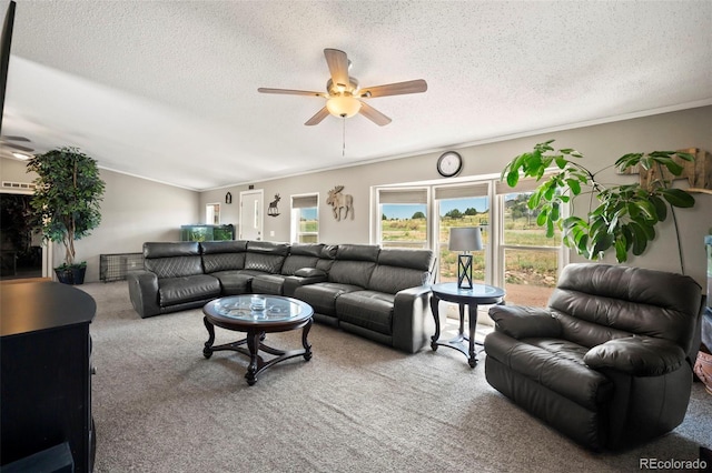 carpeted living room with a textured ceiling, vaulted ceiling, ceiling fan, and crown molding