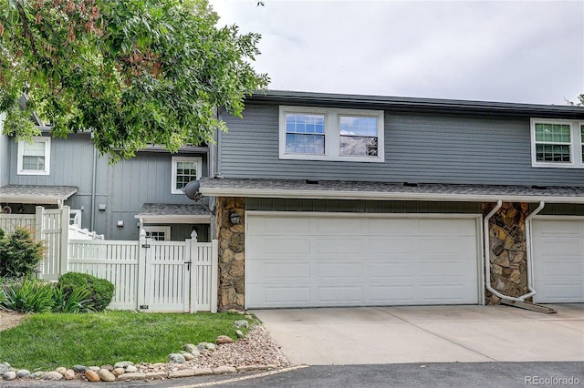 2829 S Xanadu Way, Aurora, CO 80014 - view of front of house with an attached garage, stone siding, and concrete driveway