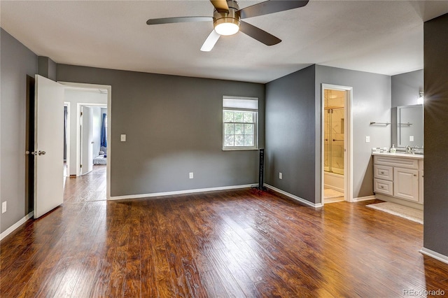 2829 S Xanadu Way, Aurora, CO 80014 - unfurnished bedroom featuring wood finished floors, ensuite bathroom, and a ceiling fan