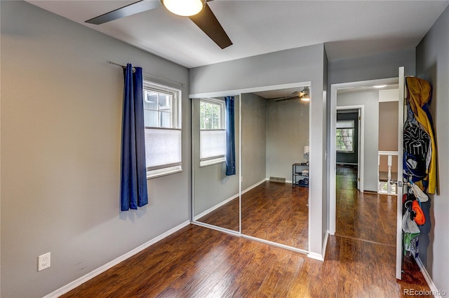 2829 S Xanadu Way, Aurora, CO 80014 - unfurnished bedroom featuring wood finished floors, multiple windows, a closet, and ceiling fan