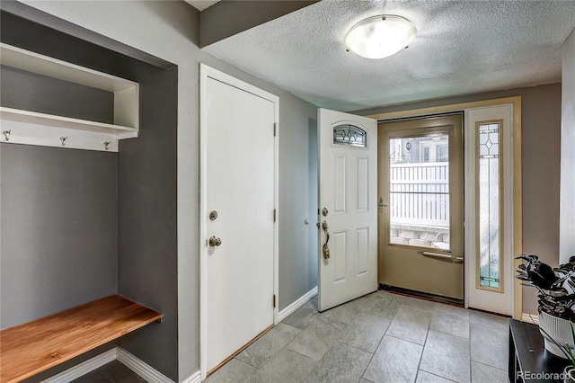 2829 S Xanadu Way, Aurora, CO 80014 - mudroom featuring a textured ceiling and baseboards