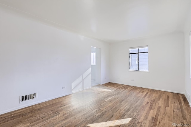 empty room with hardwood / wood-style flooring