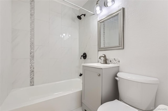 full bathroom with tiled shower / bath combo, vanity, and toilet