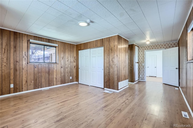 unfurnished bedroom featuring a closet and light hardwood / wood-style flooring