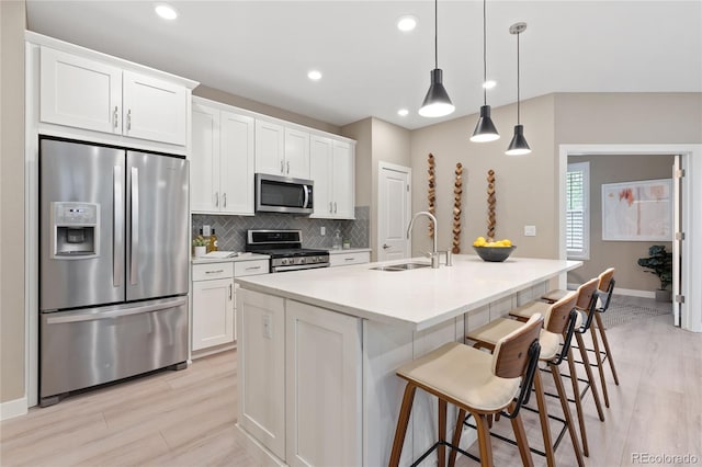 239 W Jamison Ct, Littleton, CO 80120 - kitchen featuring appliances with stainless steel finishes, a sink, tasteful backsplash, white cabinets, and recessed lighting