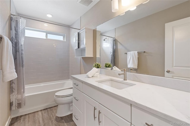 239 W Jamison Ct, Littleton, CO 80120 - full bath featuring vanity, shower / tub combo with curtain, wood finished floors, and toilet