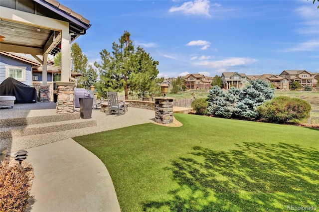 view of yard with a patio and a residential view