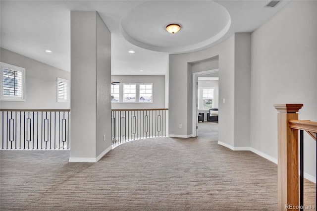 corridor featuring carpet floors, recessed lighting, baseboards, and visible vents