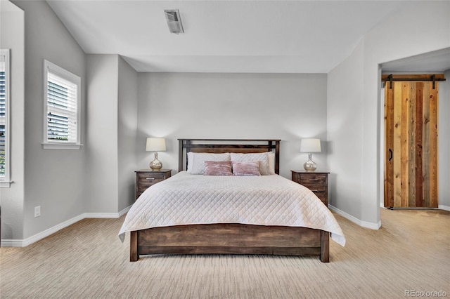 bedroom featuring baseboards, visible vents, and light colored carpet