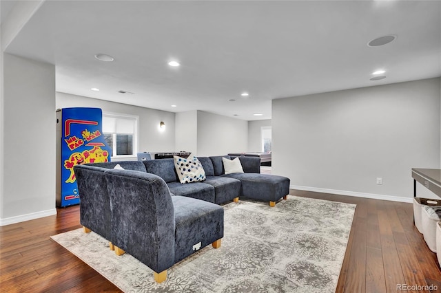 living area featuring baseboards, plenty of natural light, recessed lighting, and dark wood-type flooring