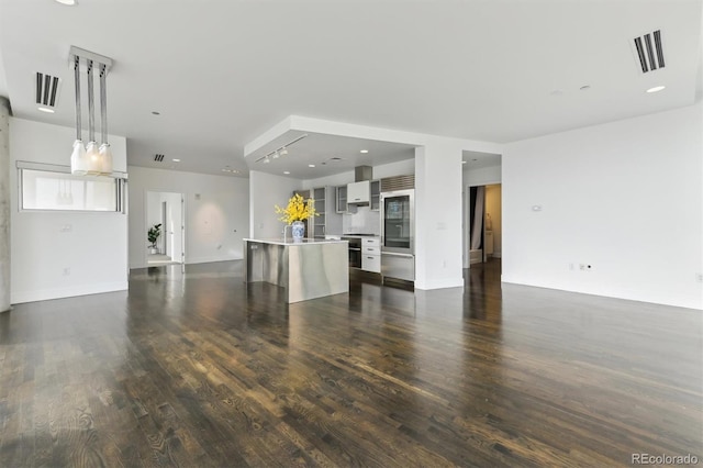 unfurnished living room featuring dark hardwood / wood-style floors