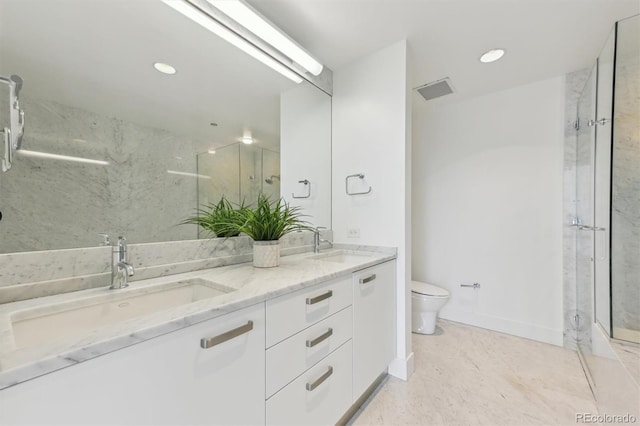 bathroom with walk in shower, vanity, and toilet