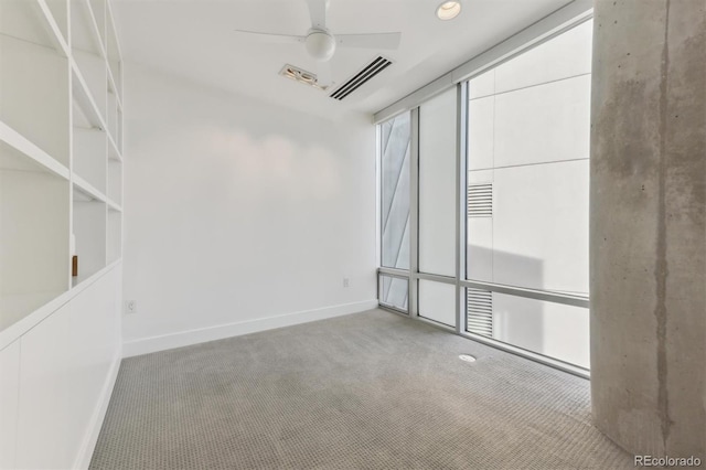 spare room with carpet floors and ceiling fan