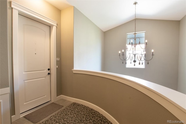 interior space featuring a chandelier and vaulted ceiling