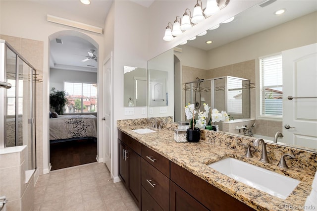 bathroom featuring walk in shower, ceiling fan, plenty of natural light, and vanity