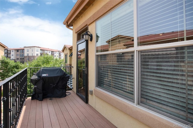 wooden terrace with a grill