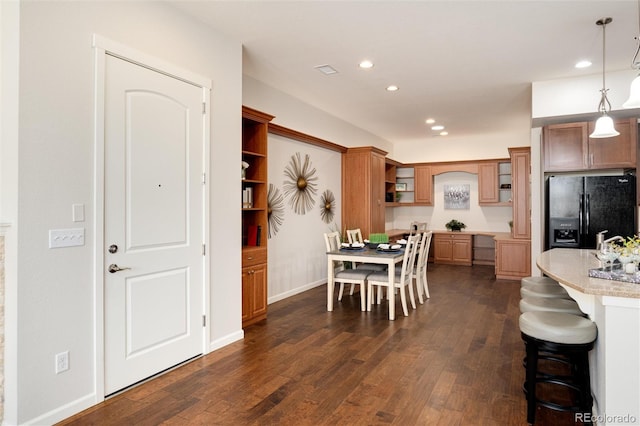 dining room with dark hardwood / wood-style flooring