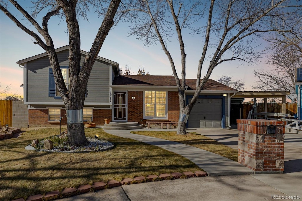 view of front facade with a yard and a garage