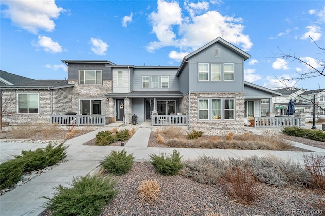 view of front of house featuring a porch and stone siding