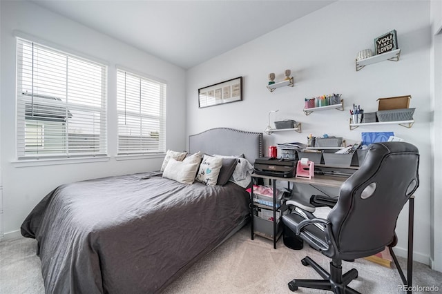 carpeted bedroom featuring baseboards