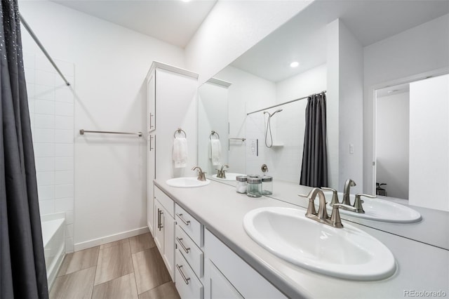 full bath with shower / bath combination with curtain, baseboards, and a sink