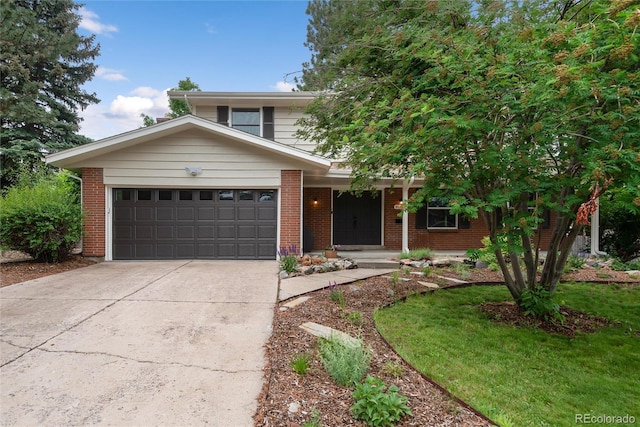 8666 E Easter Ave, Centennial, CO 80112 - view of front of home featuring a garage, concrete driveway, brick siding, and a porch