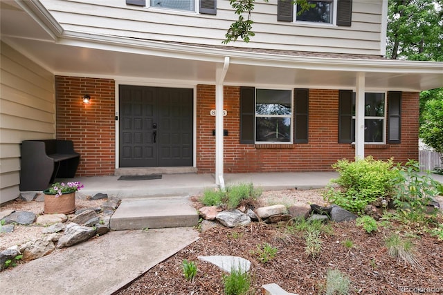 8666 E Easter Ave, Centennial, CO 80112 - doorway to property with covered porch and brick siding