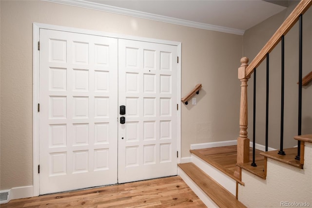 8666 E Easter Ave, Centennial, CO 80112 - foyer entrance with stairs, light wood-style floors, crown molding, and baseboards