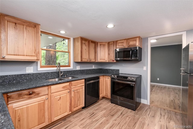 8666 E Easter Ave, Centennial, CO 80112 - kitchen featuring stainless steel appliances, a sink, light wood-type flooring, dark stone countertops, and baseboards