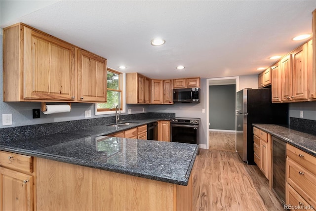 8666 E Easter Ave, Centennial, CO 80112 - kitchen featuring stainless steel appliances, a sink, beverage cooler, light wood-style flooring, and a peninsula