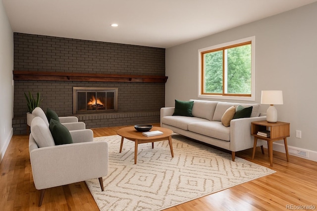 8666 E Easter Ave, Centennial, CO 80112 - living room featuring wood finished floors, a brick fireplace, baseboards, and recessed lighting