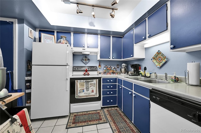 kitchen with blue cabinetry, white appliances, light tile patterned floors, and a sink