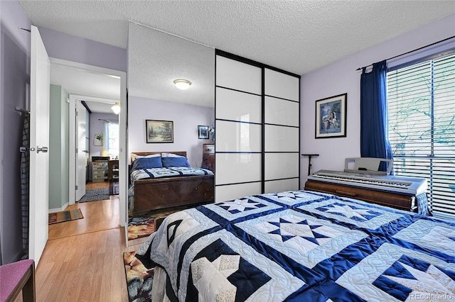 bedroom featuring a textured ceiling and wood finished floors