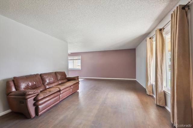 3625 E 128th Pl, Thornton, CO 80241 - unfurnished living room with wood finished floors, a textured ceiling, and baseboards