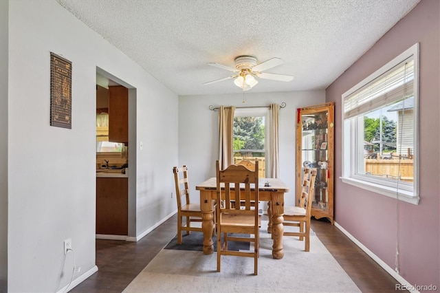 3625 E 128th Pl, Thornton, CO 80241 - dining area featuring ceiling fan, a textured ceiling, baseboards, and dark wood-type flooring