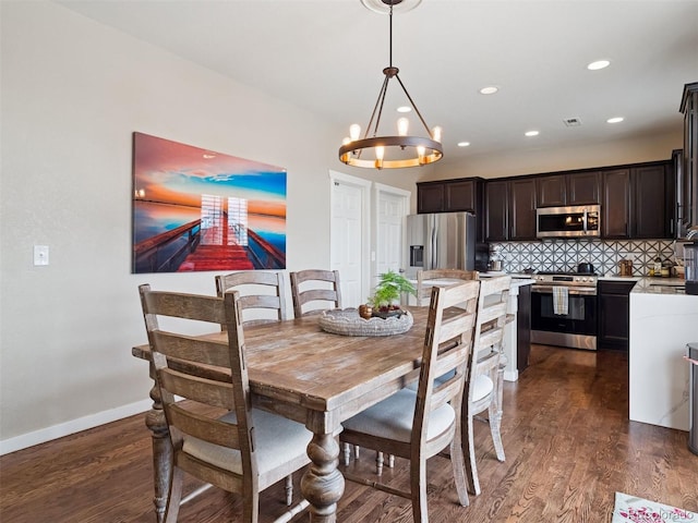 dining space with recessed lighting, dark wood-style flooring, baseboards, and a chandelier