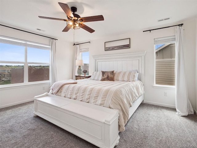 carpeted bedroom featuring a ceiling fan, baseboards, and visible vents